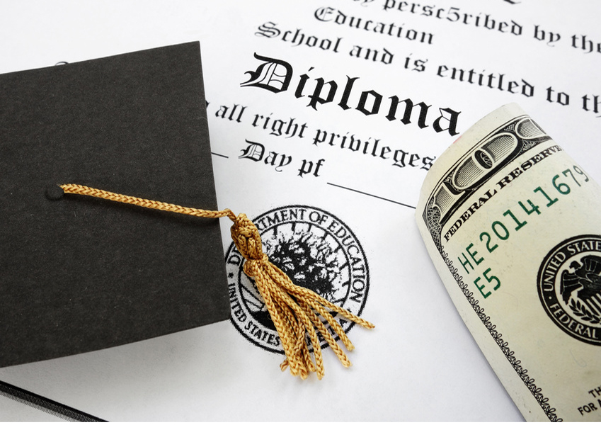 graduation cap and money on a diploma